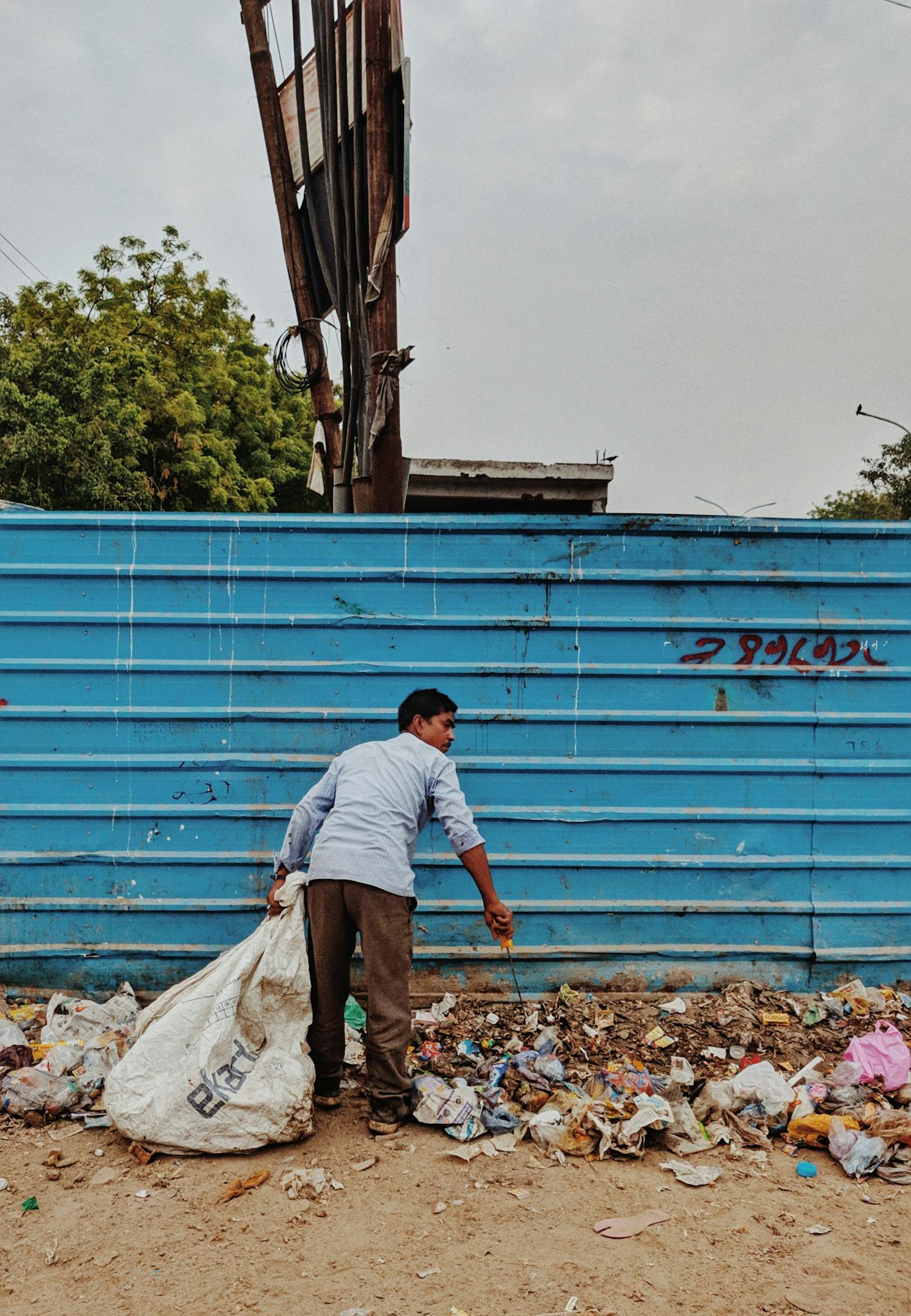 A Man Collects Trash In A Vibrant